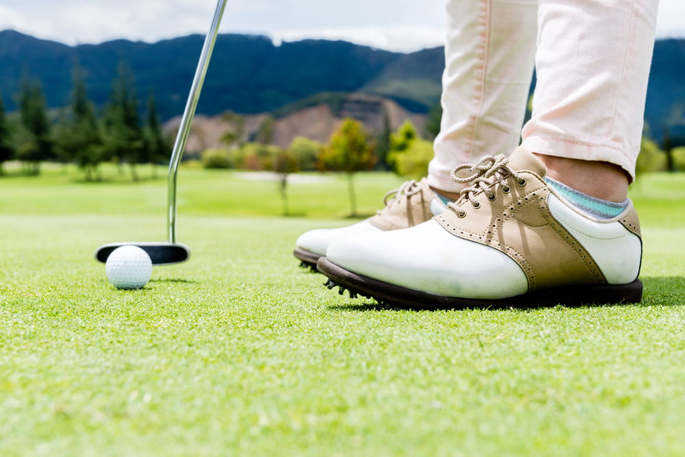 Golf Warehouse Image of a Golf player hitting a ball at the putting green