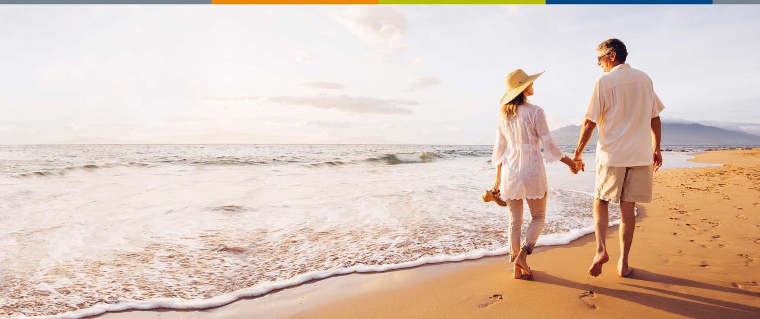 Scrip Companies Image of a couple walking along a shoreline at the beach