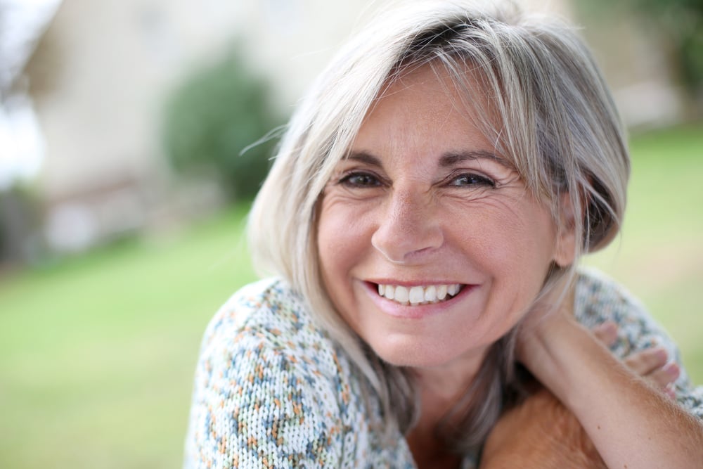 Specialty Commerce Image of serene mature woman in garden