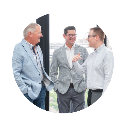 Three Snapshot team members standing and talking