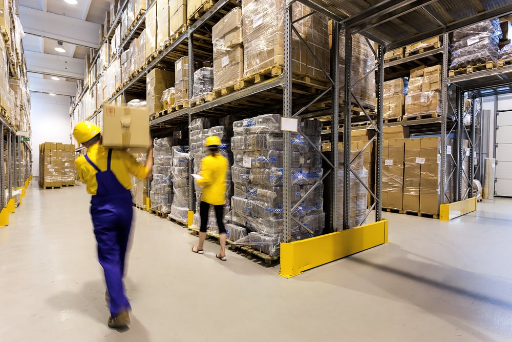 Surplus Center Image of a warehouse worker with box and manager