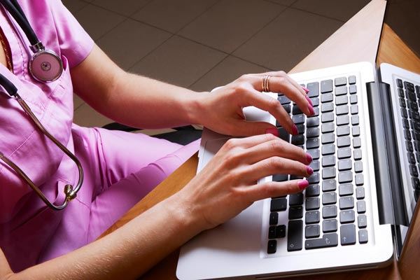 AliMed  image of nurse typing on computer