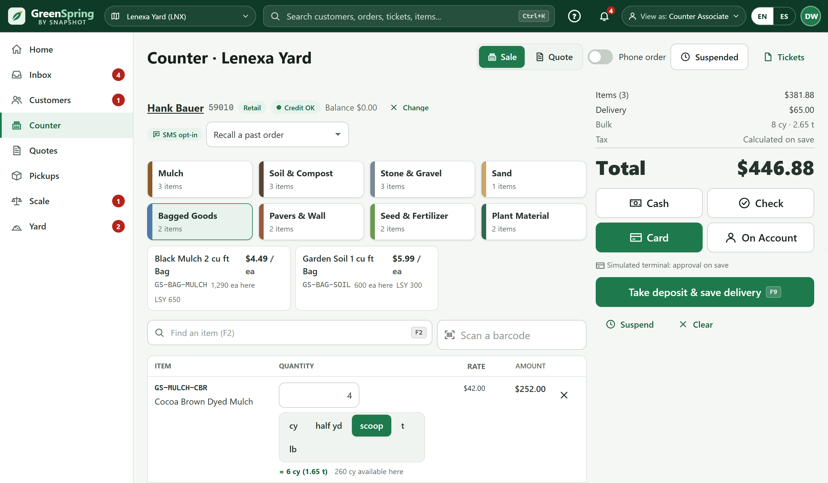 GreenSpring counter ticket for a retail customer: product categories, bulk mulch sold by the scoop, and a $446.88 total with a card deposit for delivery
