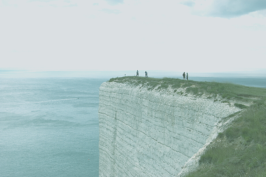 Image of people looking at the ocean on a cliff