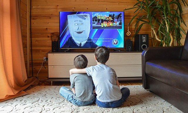 Solid Signal Image of two kids embracing while watching tv